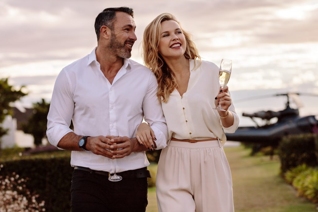 wealthy couple drinking champagne